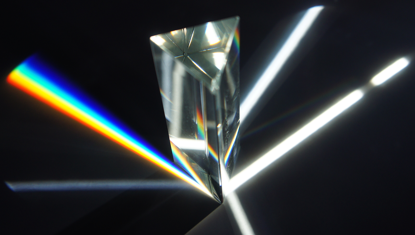 A prism deflecting white light into a rainbow